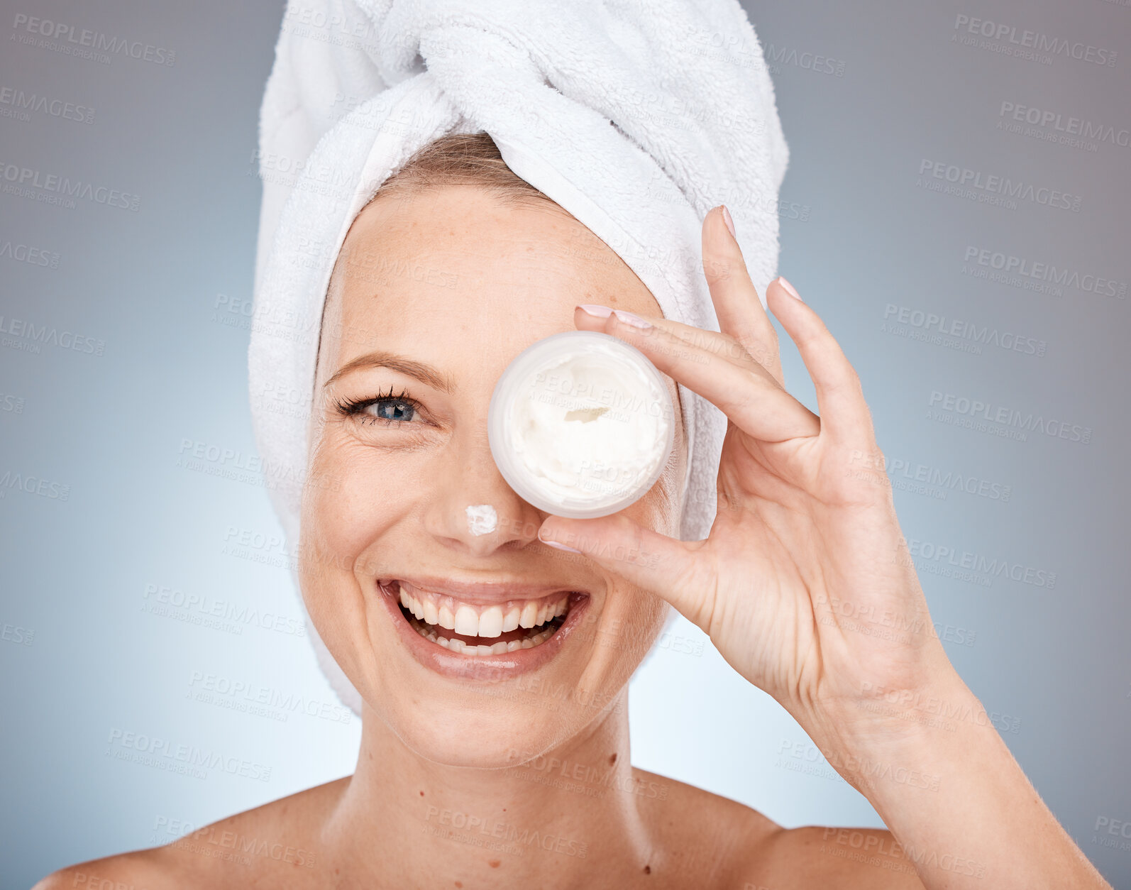 Buy stock photo Woman, face or skincare cream in grooming routine, healthcare wellness or collagen treatment on gray studio background. Portrait, happy smile or beauty model or eye care product in Canada dermatology