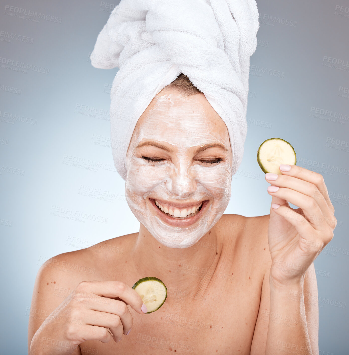Buy stock photo Laughing woman, skincare face mask and cucumber on studio background in acne dermatology, healthcare wellness or self care routine. Happy smile, beauty model and facial vegetables in organic grooming