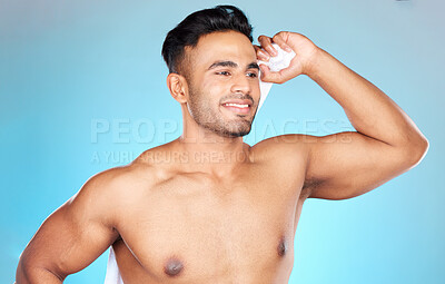 Buy stock photo Man, towel and dry after shower, cleaning and wash with clean body, hygiene and bathroom in blue studio background. Skincare, wellness and model with happy smile for beauty,morning and cosmetic