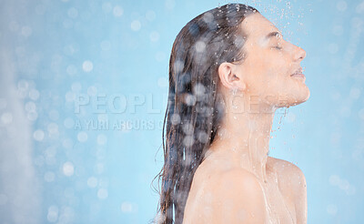 Buy stock photo Woman, water splash or showering on blue background in studio, house or home bathroom in hygiene maintenance or healthcare wellness. Beauty model, wet or skincare cleaning in morning grooming routine