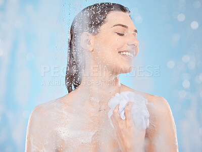 Buy stock photo Water, soap and skincare with woman in shower for beauty, self care and hygiene routine. Relax, luxury and spa with girl model and sponge for cosmetics, salon or cleaning in blue background in studio