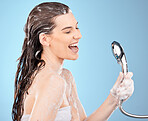 Woman, shower and singing in studio for cleaning, body or hair with smile by blue background. Happy skincare model, washing or foam from soap, shampoo or skin beauty for cosmetics, wellness or health