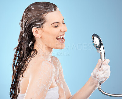 Buy stock photo Woman, shower and singing in studio for cleaning, body or hair with smile by blue background. Happy skincare model, washing or foam from soap, shampoo or skin beauty for cosmetics, wellness or health