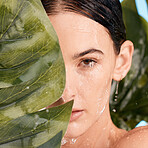 Monstera, skincare and woman in studio shower for natural makeup, beauty and eco friendly cosmetics with face aesthetic. Plant, leaf and nature with young model portrait and water drops for facial