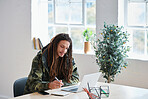 Young man with dreadlocks using laptop computer college student writing notes studying in class