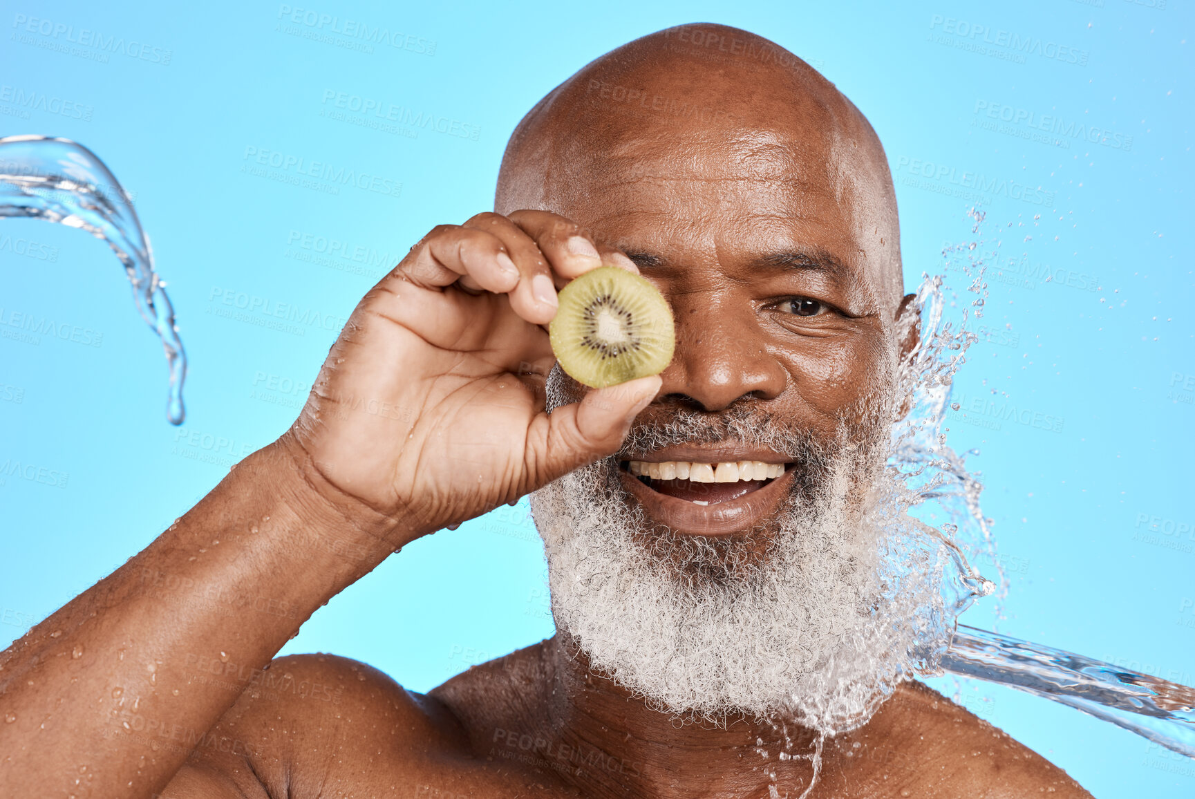 Buy stock photo Health, skincare and black man with kiwi, natural beauty or cosmetics on blue studio background. Portrait, retirement and senior male with fruit, wellness or organic facial for smooth and clear skin.