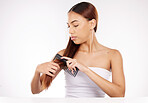 Hair care, hair style and woman comb her hair in a salon on a white studio background. Hair colour, styling and female combing her head for hair treatment or hair cut for healthy hair in a beauty spa