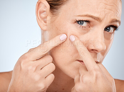 Buy stock photo Health, skincare and woman squeeze acne in face with studio background. Skin care, morning facial and lady with flaws, blemish and imperfection pop pimple or blackhead with fingers and hands.