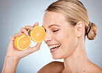 Skincare, beauty and woman with orange in studio for wellness, dermatology and luxury spa treatment. Facial, cosmetics and happy girl with fruit for natural, healthy and organic beauty products