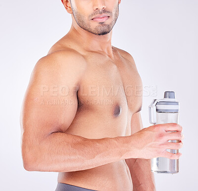 Buy stock photo Muscle, body and man with water bottle for healthcare exercise or personal trainer. Wellness model, training or fitness strength motivation and workout with strong hands in grey studio background