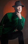 Aesthetic, fashion and black man with vitiligo in studio isolated on a background. Thinking, beauty and stylish male model posing in designer hat, luxury clothing or trendy green jersey on a backdrop