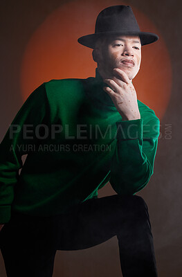 Buy stock photo Aesthetic, fashion and black man with vitiligo in studio isolated on a background. Thinking, beauty and stylish male model posing in designer hat, luxury clothing or trendy green jersey on a backdrop