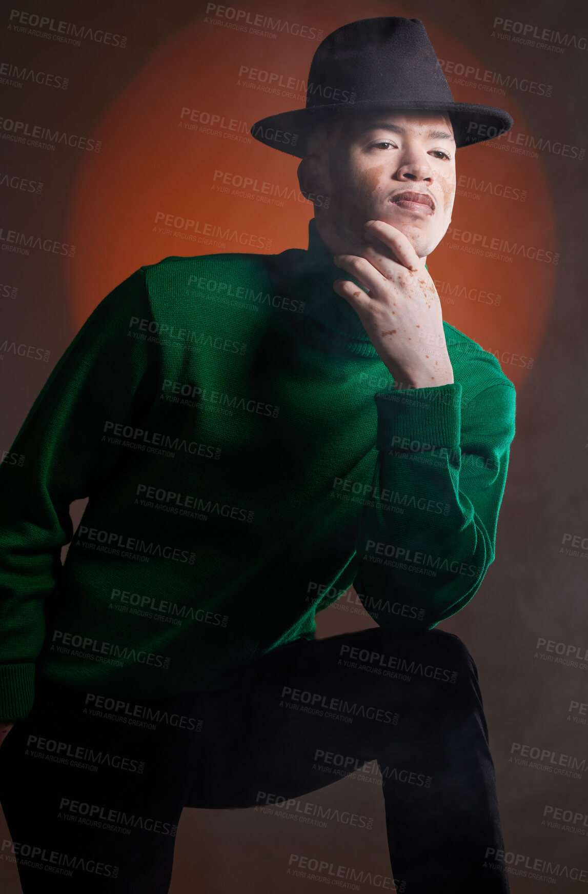 Buy stock photo Aesthetic, fashion and black man with vitiligo in studio isolated on a background. Thinking, beauty and stylish male model posing in designer hat, luxury clothing or trendy green jersey on a backdrop