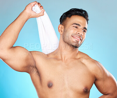 Buy stock photo Face, skincare and body of man with towel in studio isolated on a blue background. Thinking, cleaning and personal hygiene of male model from Brazil with cotton cloth to wipe after shower or bathing.