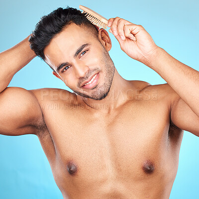 Buy stock photo Beauty, hair and brush with portrait of man for grooming, hygiene or self care routine. Salon, hairstyle and treatment with model for cosmetics, brushing and product against blue background in studio