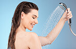 Faucet, shower and woman with water for cleaning, skincare and body care in studio on blue background. Wellness, healthcare and girl washing with water drops for hydration, luxury spa and self care