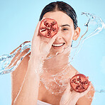 Face, pomegranate and skincare woman with water splash in studio for nutrition, vitamin c product promotion in studio blue mockup. Beauty model, healthy fruits and cosmetics or dermatology marketing