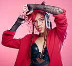 Punk, fashion and woman with makeup on face for metal, rock and edgy style against a pink studio background. Expression, funky and portrait of latino model or person in a 90s clothes and mockup space
