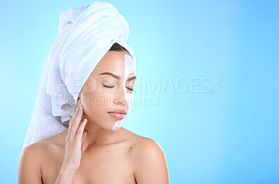 Buy stock photo Face, skincare cream or woman in studio for beauty self care  using dermatology product after shower in bathroom. Mask, relaxing or model grooming with facial cosmetics with mockup on blue background