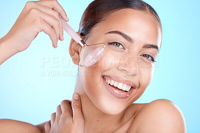 Buy stock photo Skincare, roller and portrait of a woman with a beauty tool for anti aging and firm skin on a blue studio background. Aesthetic, skin care and facial treatment with female and derma roller 