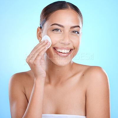Buy stock photo Skincare portrait, woman with cotton product and cleaning face in studio with blue background aesthetic. Makeup removal for healthy hygiene, luxury cosmetics facial and happy girl with beauty glow