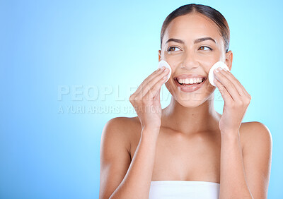 Buy stock photo Skincare, face and woman with cotton pads, cosmetics and wellness on blue studio background. Makeup remover, female and Mexican girl with smile, natural beauty and confident for clear and smooth skin