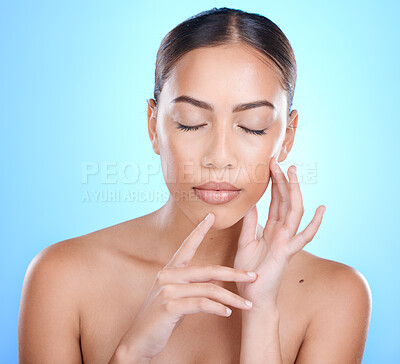 Buy stock photo Face, beauty and skincare with a model black woman in studio on a blue background for natural treatment. Facial, eyes closed and cosmetics with an attractive young female posing to promote skin care