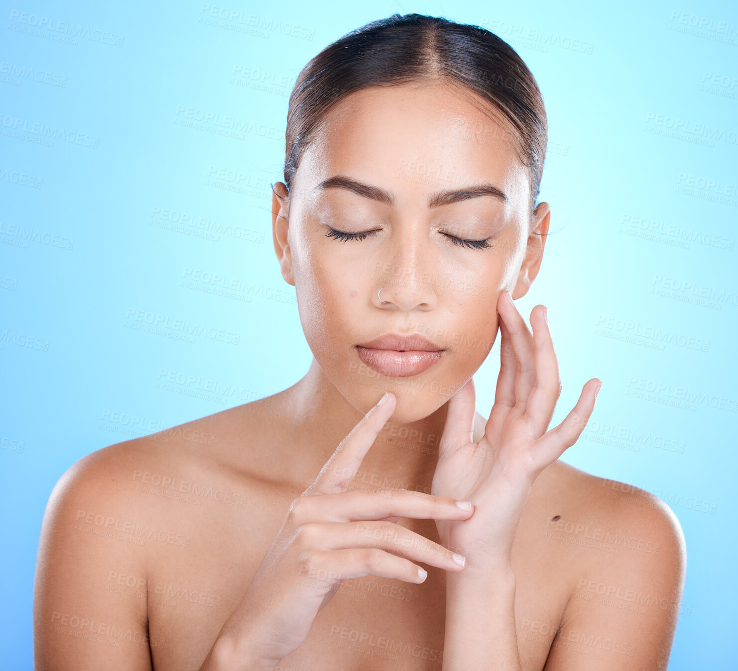 Buy stock photo Face, beauty and skincare with a model black woman in studio on a blue background for natural treatment. Facial, eyes closed and cosmetics with an attractive young female posing to promote skin care