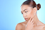 Beauty, woman and skincare for a cosmetic treatment on a blue studio background for health. Dermatology, skin care and female with facial wellness aesthetic on a mockup or copyspace backdrop
