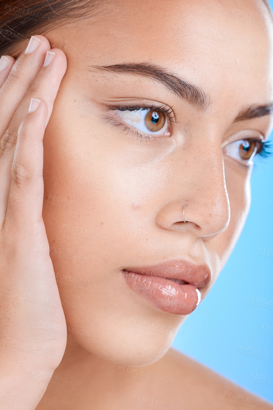 Buy stock photo Face, beauty and skincare with a model black woman in studio closeup on a blue background for wellness. Botox, microblading and cosmetics with an attractive young female inside for luxury treatment