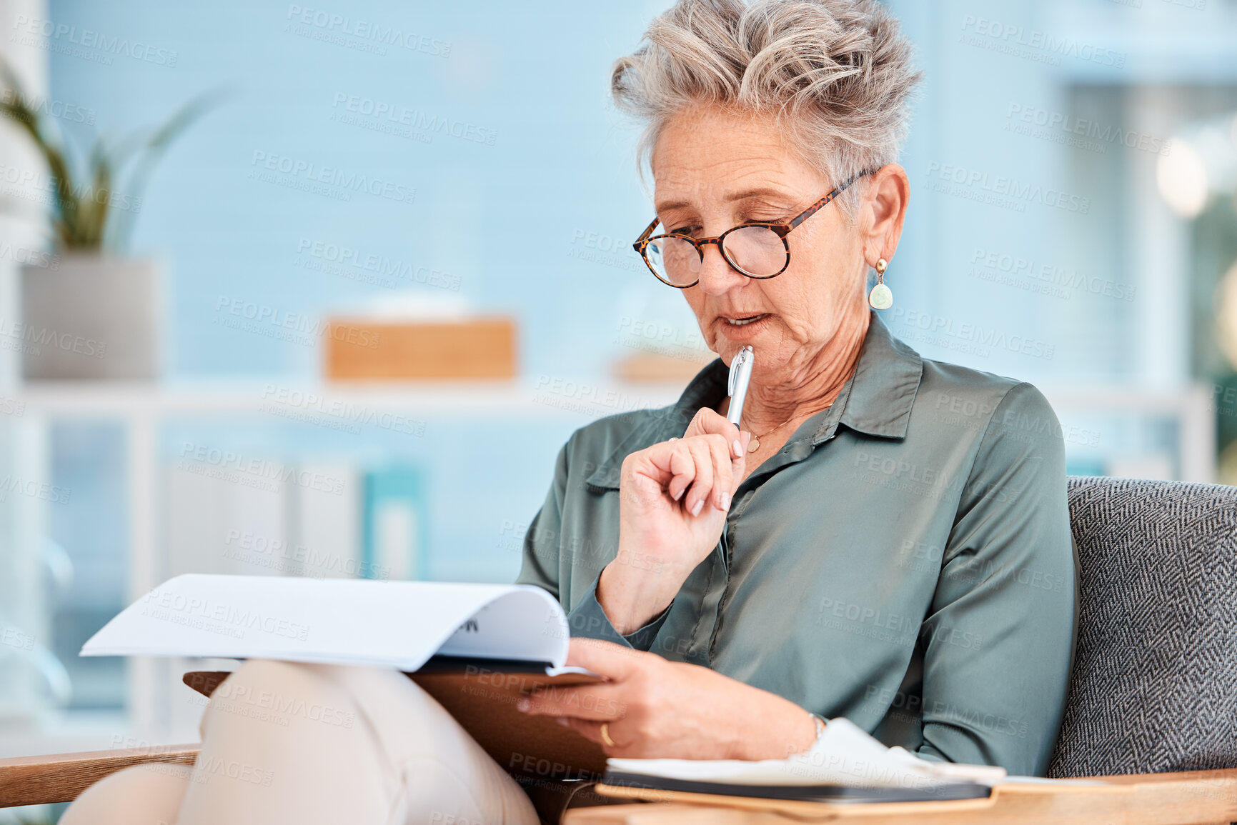 Buy stock photo Thinking, documents and business with a senior woman reading while sitting in a chair at work. Data, writing and idea with a mature female CEO, manager or boss contemplating growth or development