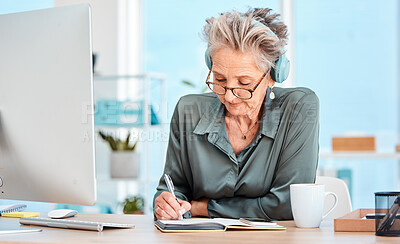 Buy stock photo Senior woman, writing and schedule in office with music headphones at desk, reading or focus. Elderly secretary, receptionist or communication executive at table with notebook, pc or listen to radio
