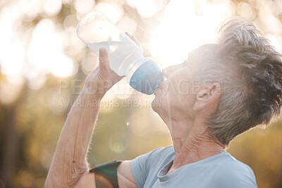 Buy stock photo Fitness, senior woman and drinking water during a break from exercise workout or training in a park. Elderly woman, water bottle and drink for thirsty hydration during sporty activity outside