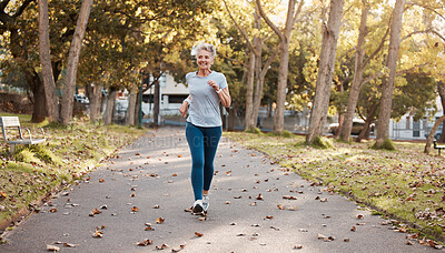Buy stock photo Exercise, senior and woman running in park for fitness, health and wellness mock up. Sports, retirement and happy elderly female from Canada jog, exercising or training outdoors alone for marathon.