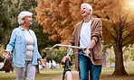 Elderly, couple and bike in the park for nature walk and exercise outdoor, senior man laugh at funny joke with old woman and eco friendly travel. Walking, cycling bicycle and retirement in New York.