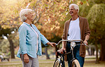Bike, senior couple and ride outdoor for health, wellness, loving and bicycle. Retirement, love and mature man with elderly woman, cycling and bonding together for hobby, happy or riding for wellness
