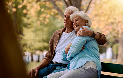 Buy stock photo Couple, elderly and hug in park during retirement, sitting on park bench with love and spending quality time outdoor. Happy, trust and support with marriage, senior man and woman retired in New York.