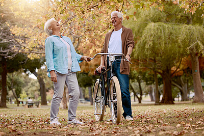 Buy stock photo Nature, laugh and senior couple with bicycle to travel in autumn park for funny romantic date, outdoor peace or freedom. Love, retirement marriage bond and laughing man and woman with cycling bike