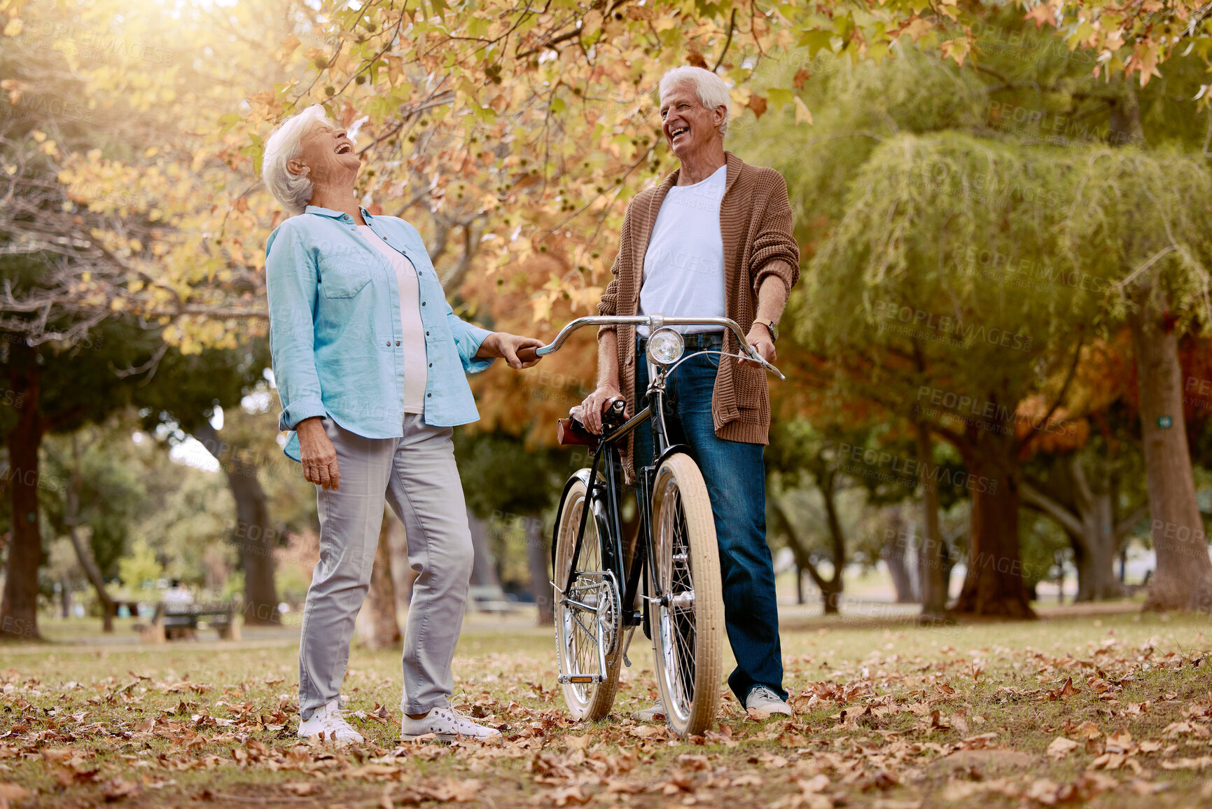 Buy stock photo Nature, laugh and senior couple with bicycle to travel in autumn park for funny romantic date, outdoor peace or freedom. Love, retirement marriage bond and laughing man and woman with cycling bike