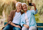 Senior couple, phone selfie and smile on park bench for love, care and social media profile picture of a happy retirement. Old man and woman outdoor together for happiness, support and bonding