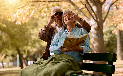 Buy stock photo Park, bench and binoculars with a senior couple birdwatching together outdoor in nature during summer. Spring, love and book with a mature man and woman bonding while sitting in a garden for the view