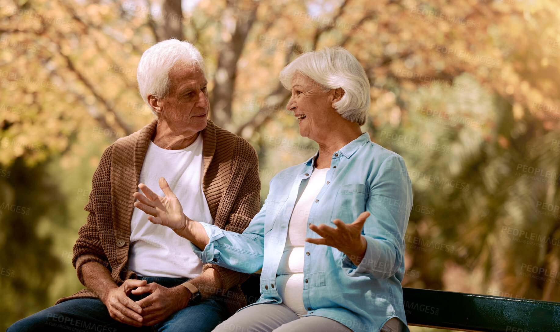 Buy stock photo Nature, park and retirement with a senior couple sitting together on a wooden bench outdoor in a garden. Spring, love and summer with a mature man and woman bonding outside in the countryside