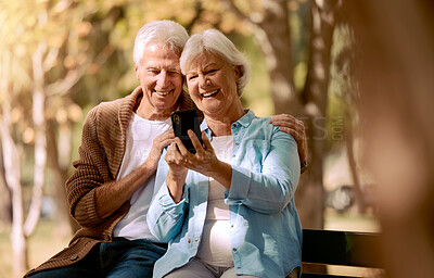 Buy stock photo Relax, happy and phone with old couple in park for video call, social media and communication. Smile, health and internet with man and woman on bench in nature for retirement, 5g and technology