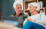 Senior couple, laptop and credit card for online shopping, ecommerce and paying bills online while talking about savings, investment and retirement. Old man and woman together for banking payment