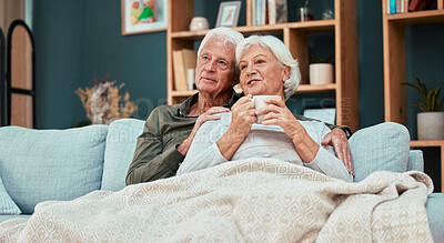 Buy stock photo Relax, love and coffee with old couple on sofa with blanket for cuddling, affectionate or watching tv. Cozy, comfortable and retirement with man and woman in living room for break, marriage or lounge