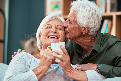 Buy stock photo Coffee kiss, love and senior couple smile for retirement, conversation and relax in the living room of a house. Home tea, affection and elderly man and woman with comic communication in the lounge