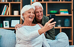 Senior couple, selfie and video call with phone in living room, lounge or family home. Happy, elderly and old man, woman and people taking photograph on smartphone, mobile and technology in apartment