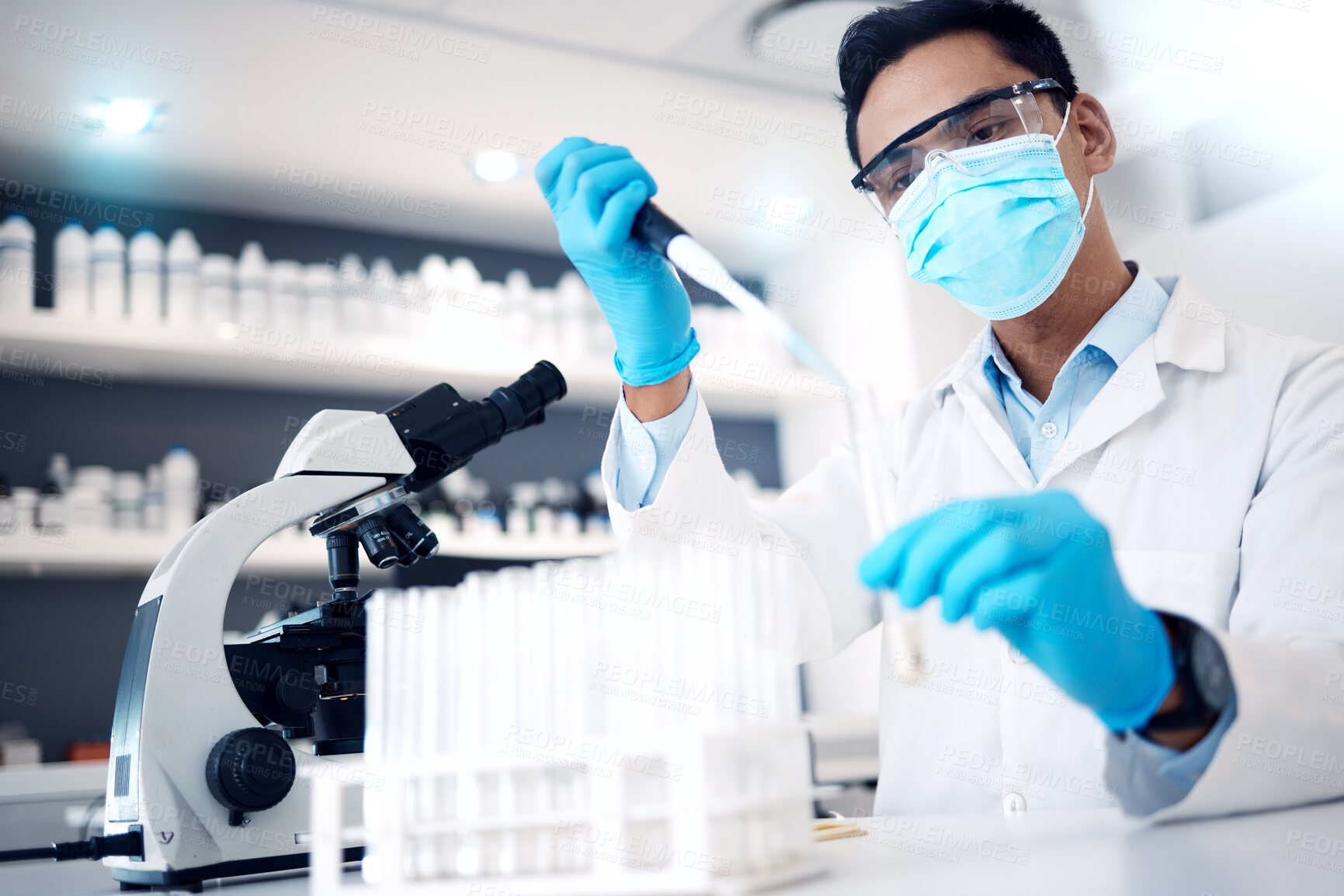 Buy stock photo Covid, microscope and experiment with a man scientist working on research or innovation in a laboratory. Doctor, medicine and safety with a male scientist at work in a lab for a corona virus cure