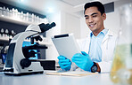 Science, tablet and microscope with a man at work in a laboratory for research or innovation. Doctor, medicine and healthcare with a male engineer working in a lab for future medical development