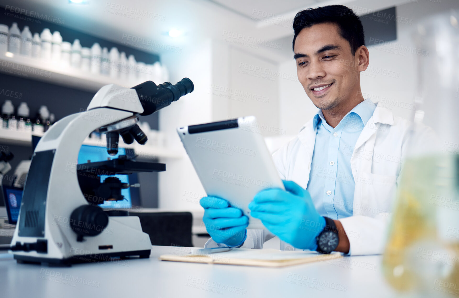 Buy stock photo Science, tablet and microscope with a man at work in a laboratory for research or innovation. Doctor, medicine and healthcare with a male engineer working in a lab for future medical development